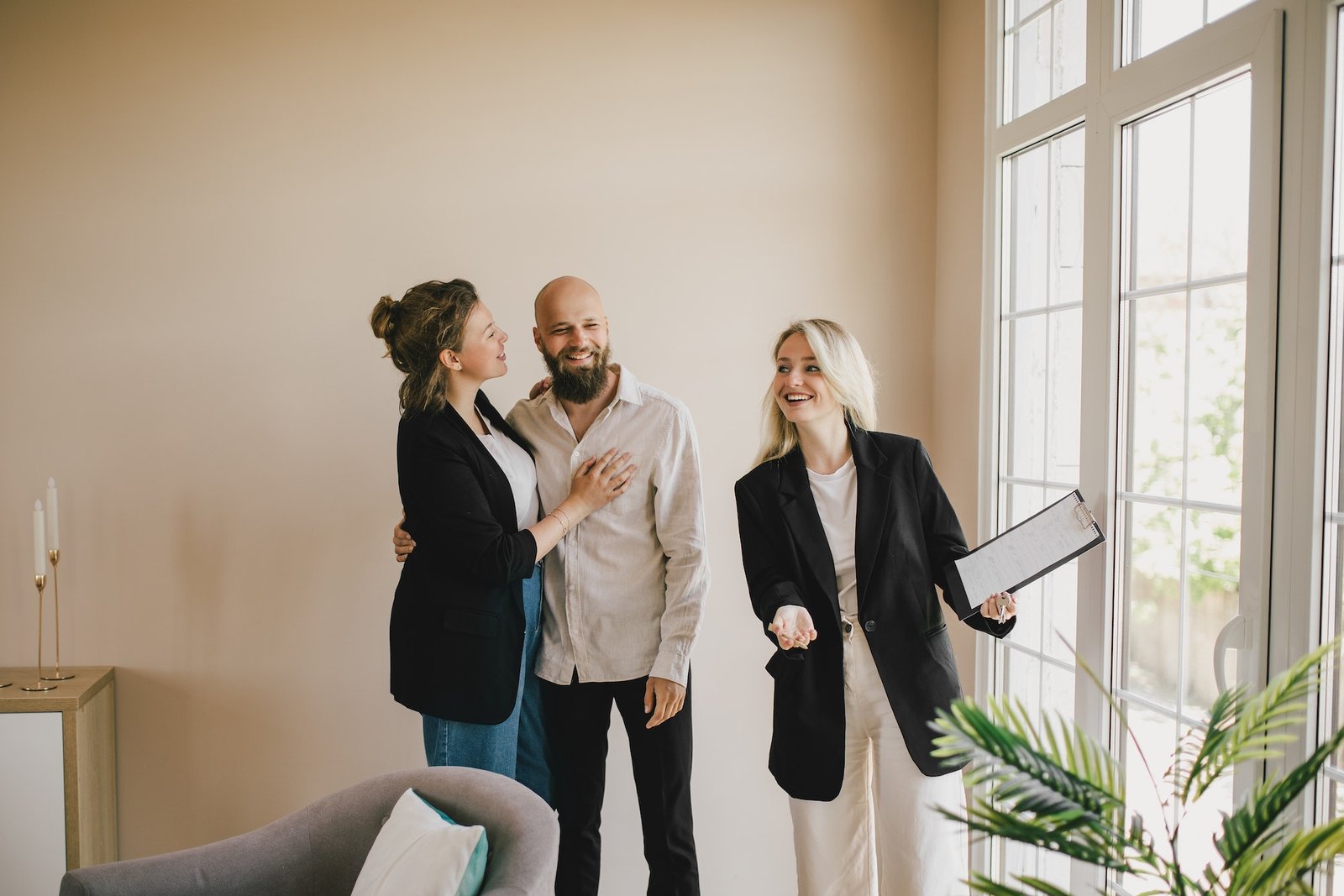 real-estate-agent-demonstrates-a-new-apartment-to-a-happy-couple-buying-a-property-.jpg